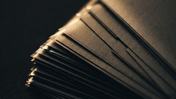 Close-up of a trading card in a clear grading slab next to a raw card in a sleeve