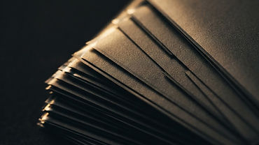 Close-up of a trading card in a clear grading slab next to a raw card in a sleeve