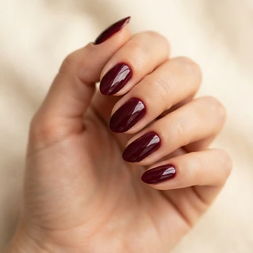 Deep burgundy glossy gel manicure on medium almond-shaped nails