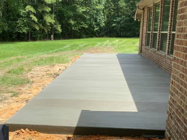 New concrete patio poured beside the house