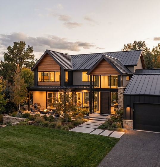 Charcoal standing-seam metal roof with raised vertical seams on a modern home at dusk