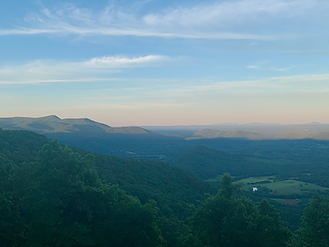 A wide overlook of green ridges and valley farmland in the Blue Ridge