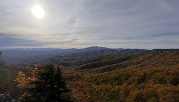 Sun breaking over a valley of fall color in the Blue Ridge