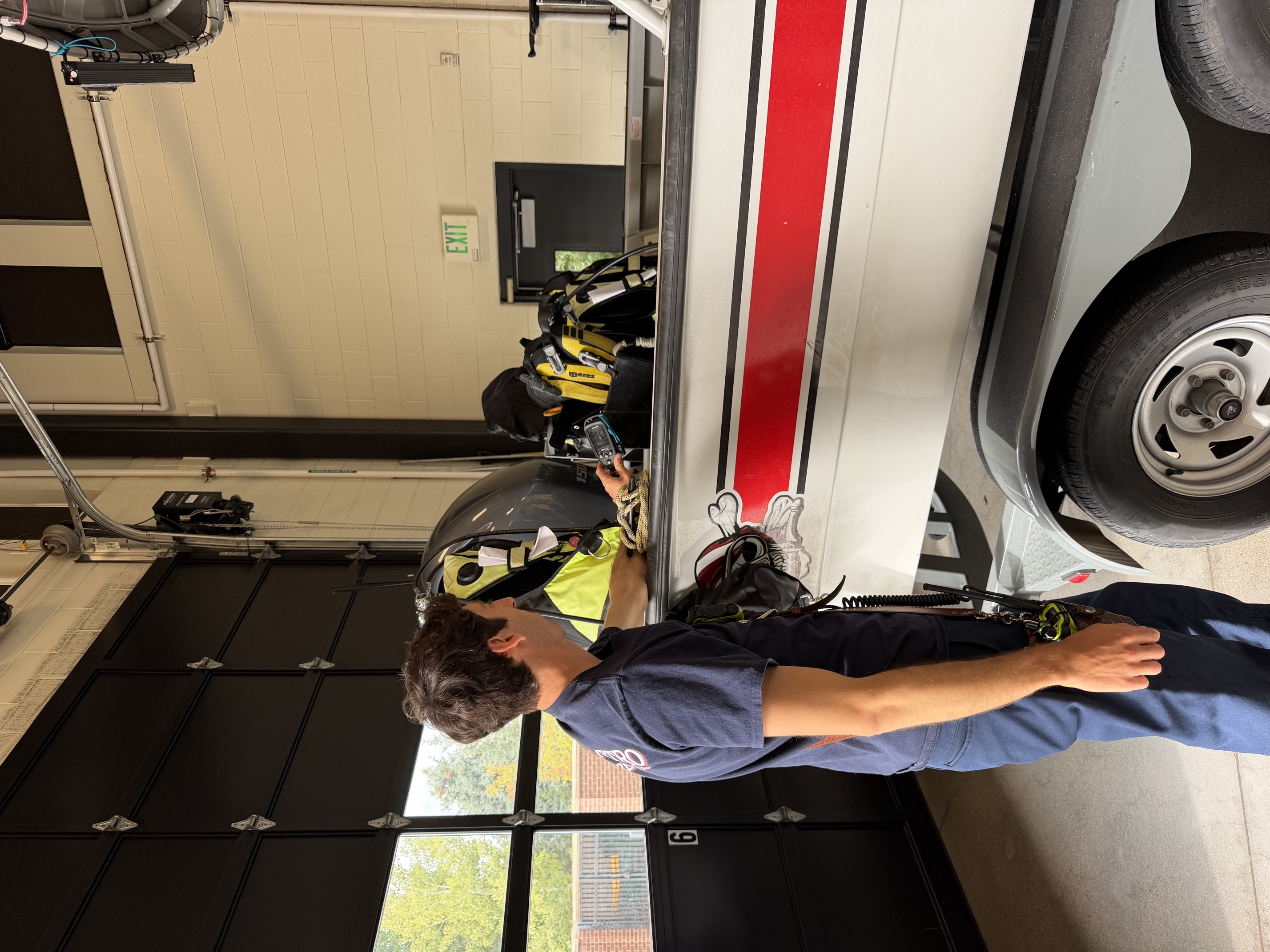 South Metro Fire Rescue firefighter working with dive equipment beside a rescue boat