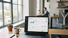 Modern and clean office desk with a computer displaying analytics and web architecture plans.