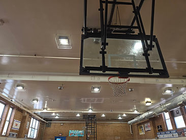 Indoor basketball court with ceiling-mounted lighting