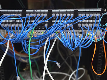 48-port network patch panel with labeled blue patch cables