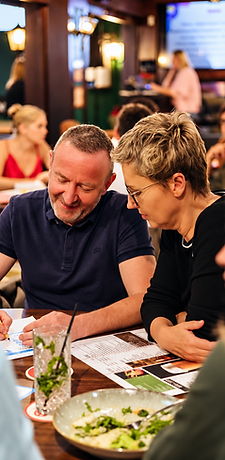 Couple ordering from the menu at Shakespeare Gastropub
