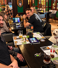 Friends gathered around a table with their dog