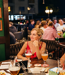Guest enjoying a beer in the warm pub atmosphere