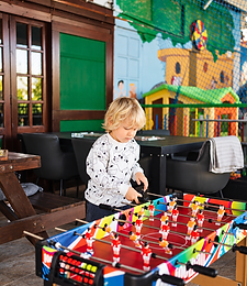 Young guest playing foosball table football