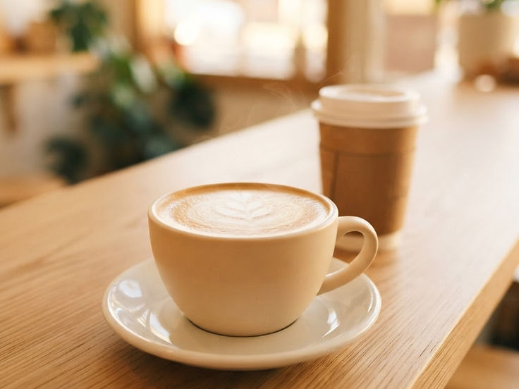 A flat white coffee in a ceramic cup