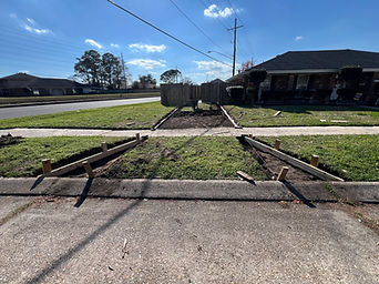 Driveway site with soil preparation and wooden concrete forms.
