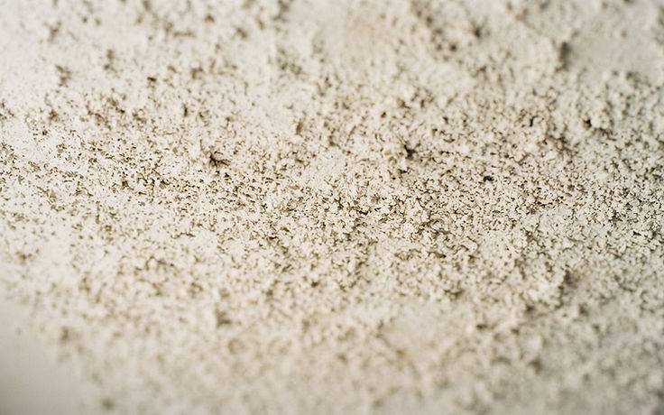 Close-up of an older popcorn textured ceiling surface