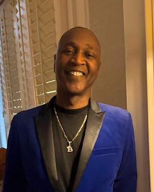 Marcus Branche, founder of Marcus B Entertainment, in a royal blue velvet blazer