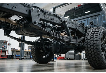 Illustrative black undercoating on truck chassis and suspension