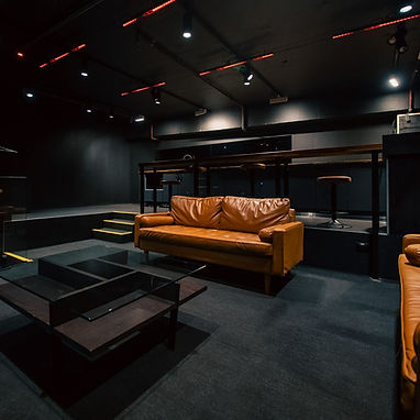 Opera Box lounge with leather couches and stage view
