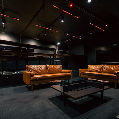 Opera Box seating area with leather couches and coffee table