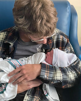 Hunter Selph holding his newborn