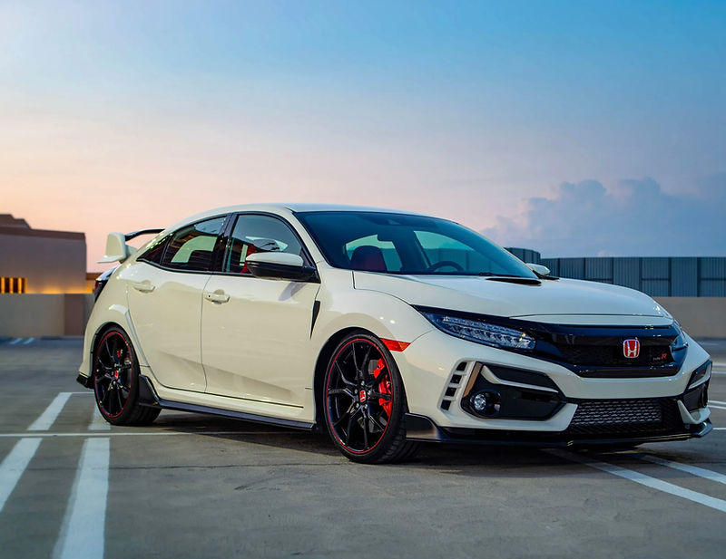 White Honda Civic Type R parked on a concrete rooftop at twilight