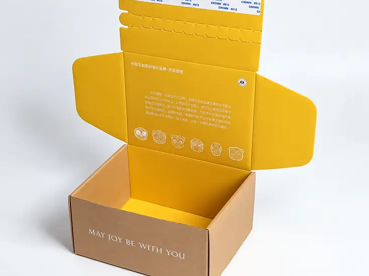 Open kraft mailer box with a yellow printed interior