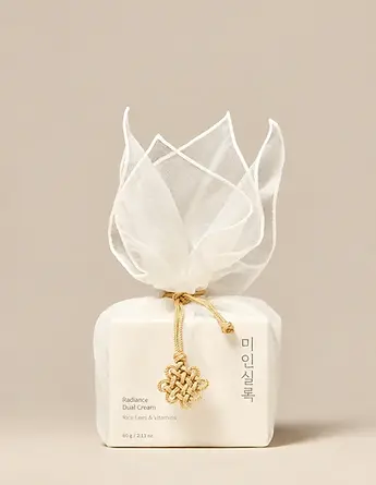 Cream fabric gift wrap with decorative cord closure