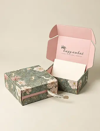 Floral printed mailer boxes with pink interiors and a tear-open strip