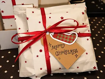 Paper wrapped gift with red ribbon and kraft gift tag
