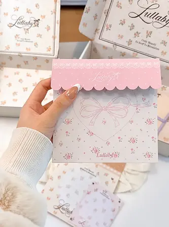 Coordinated floral packaging card held in front of mailer boxes