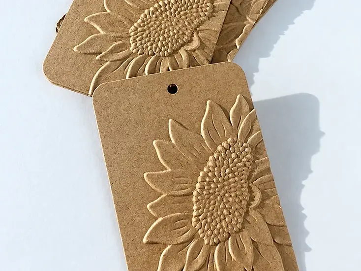 Three kraft paper tags with embossed sunflower artwork