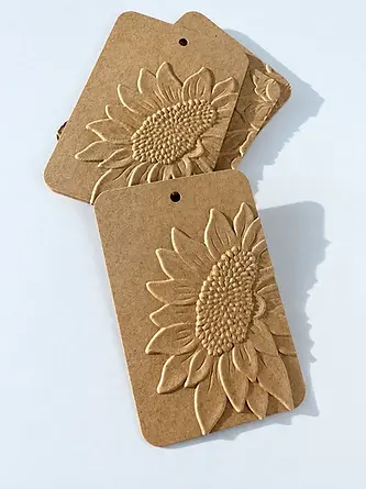 Three kraft paper tags with embossed sunflower artwork