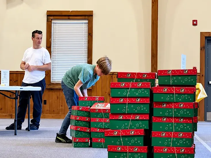 Stacked red and green gift boxes in an indoor presentation scene