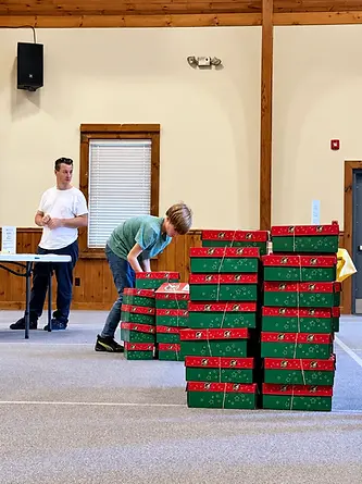 Stacked red and green gift boxes in an indoor presentation scene