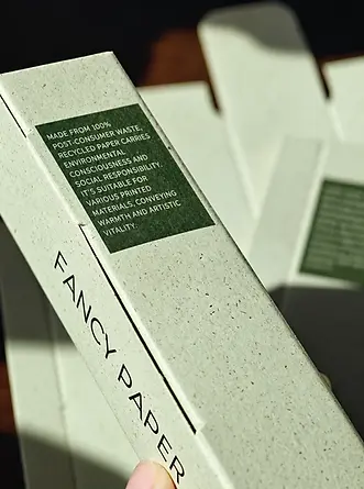 Textured specialty paperboard folding carton with printed panel