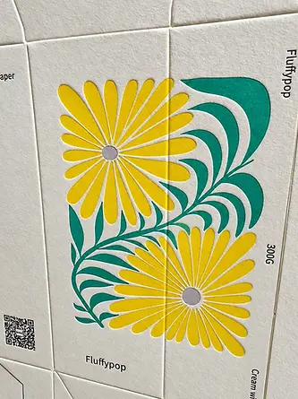 Printed floral paperboard product carton with folding structure