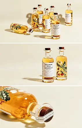 Glass bottles with labels and cork closures in a coordinated set