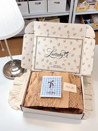 Floral mailer box with honeycomb wrapping paper and printed cards