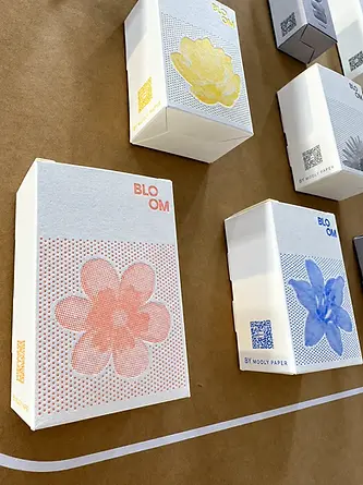 Printed floral paperboard product carton with folding structure