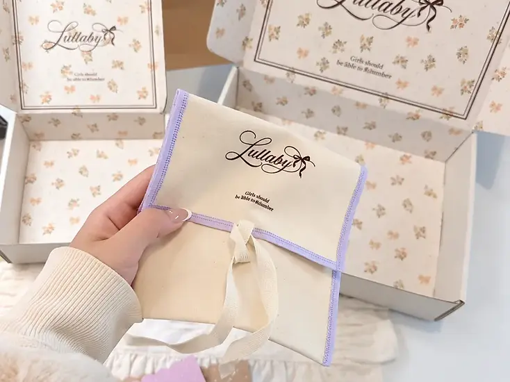Branded fabric pouch with coordinated floral mailer boxes