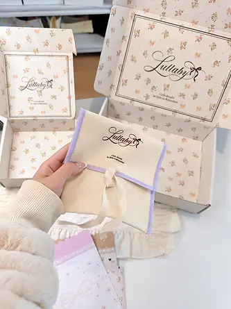 Branded fabric pouch with coordinated floral mailer boxes