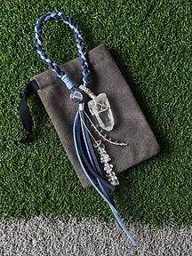 Gray fabric drawstring pouch with a blue braided crystal wristlet