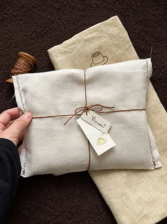 Folded fabric wrap tied with string and a paper hang tag