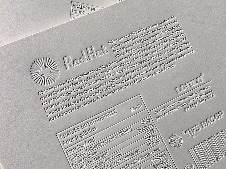 Embossed product information on a white paper card