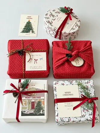 Coordinated Christmas boxes and wraps with red ribbons and printed cards