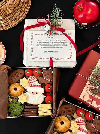 Open treat gift box with branded card and red ribbon