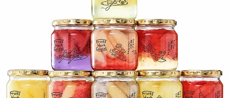 Glass jars with printed labels and gold-colored lids