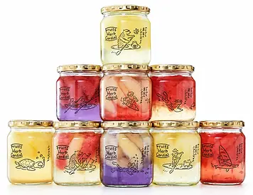 Stacked decorated glass jars with gold colored lids