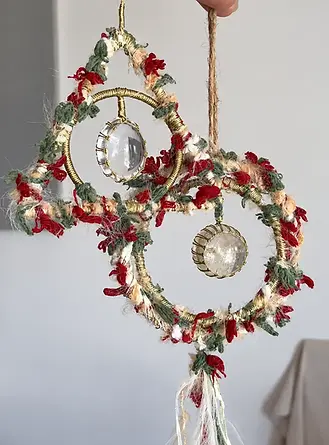 Yarn-wrapped brass ring ornaments with crystal cabochons, hung on jute cord