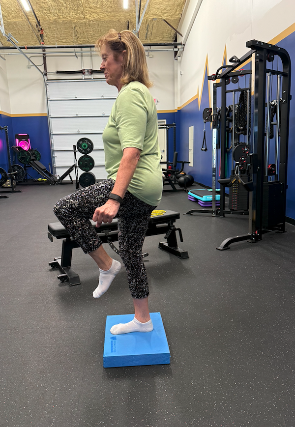 A single-leg balance drill on a foam pad at The Lab