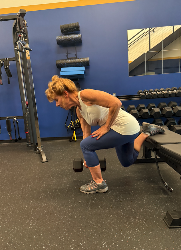 A client at The Lab performs a Bulgarian split squat under coach supervision